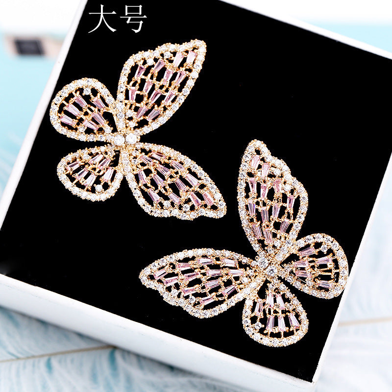 2025 Korean version exaggerated fashion hollow pink zircon S925 silver needle female Internet celebrity earrings butterfly stud earrings wholesale