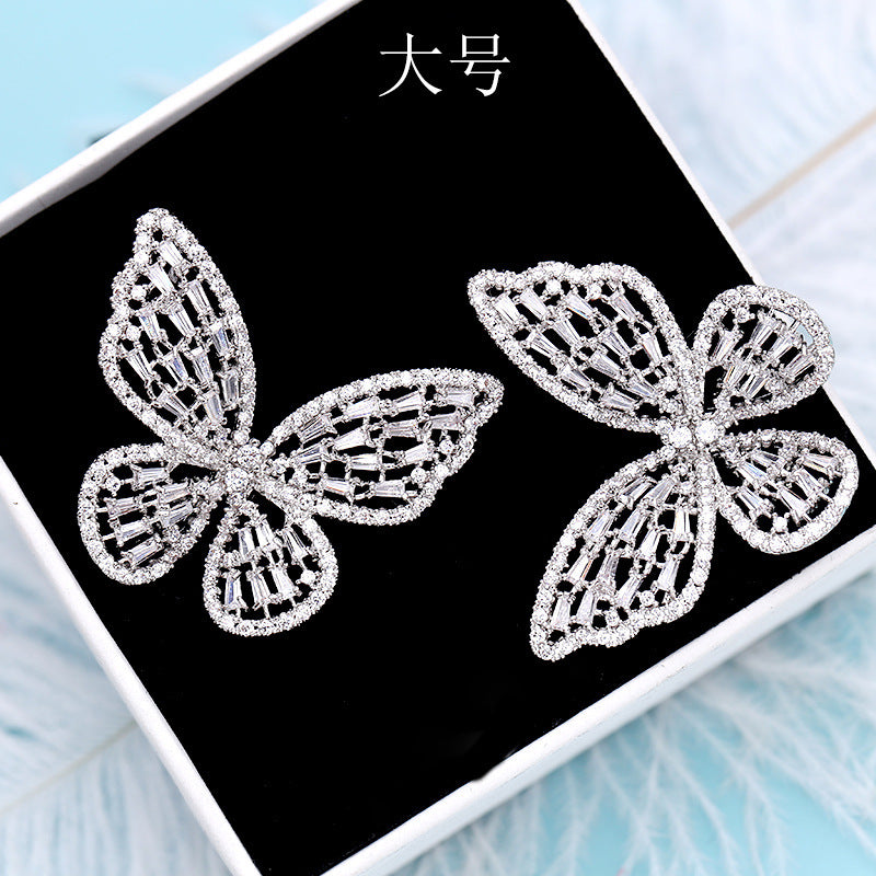 2025 Korean version exaggerated fashion hollow pink zircon S925 silver needle female Internet celebrity earrings butterfly stud earrings wholesale