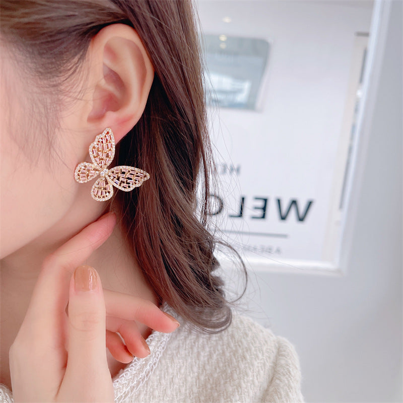 2025 Korean version exaggerated fashion hollow pink zircon S925 silver needle female Internet celebrity earrings butterfly stud earrings wholesale