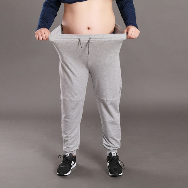 Men Big Size Solid Sweatpants Spring Elastic Narrow Feet Stretch Pants Loose Plus Size Casual Cotton Jogger Trousers 5XL 6XL 7XL